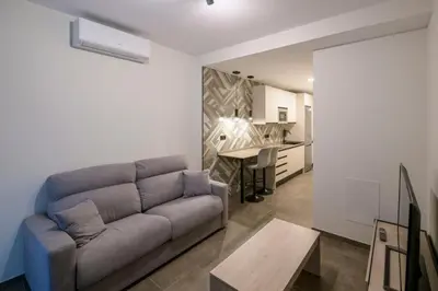a living room with a couch and a table at Céntrico 4 personas Ciudad Ciencias in Valencia