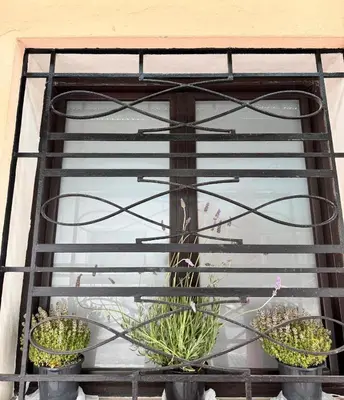 a window with three potted plants in it at The Robby's home in Valencia