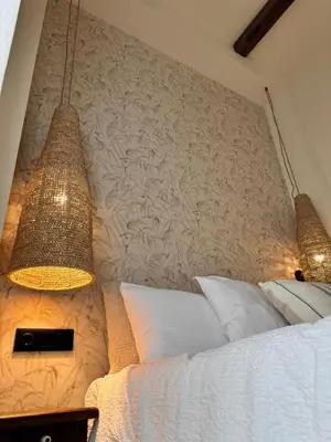 a bedroom with a bed with two lamps on it at The Robby's home in Valencia