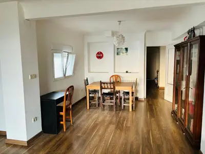 a kitchen and dining room with a table and chairs at Atico con vistas al atardecer admitanse mascotas in El Puig