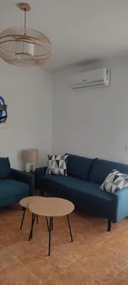 a living room with a blue couch and a table at Magnifico apartamento de playa in Moncófar