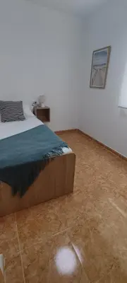 a bedroom with a bed and a tile floor at Magnifico apartamento de playa in Moncófar