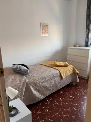 a bedroom with a bed with a blanket on it at Rincón Valenciano - Campanar in Valencia