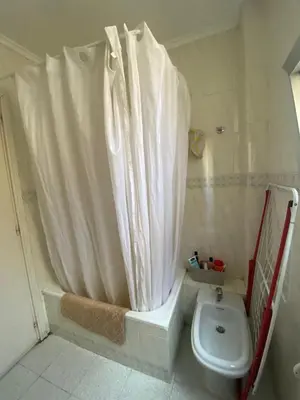 a bathroom with a shower curtain and a toilet at Rincón Valenciano - Campanar in Valencia