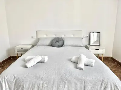 a large white bed with two pillows on it at El sitio de Ana in Burriana