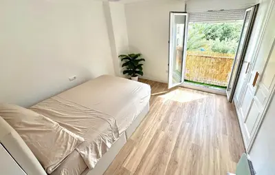 a bedroom with a bed and a large window at Beach Front Apartment In Sagunto in Sagunto