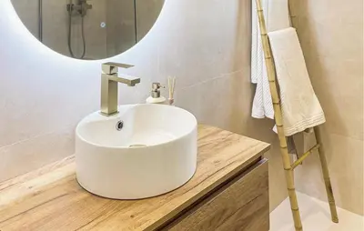 a bathroom with a white sink and a mirror at Beach Front Apartment In Sagunto in Sagunto