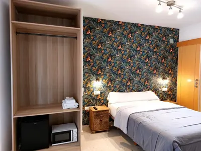 a bedroom with a bed and a wall mural at ATTIC ROOMs VALENCIA in Valencia