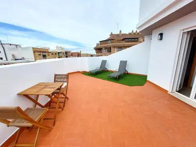 a balcony with a table and chairs on a building at ATTIC ROOMs VALENCIA in Valencia