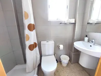 a bathroom with a toilet and a sink at ATTIC ROOMs VALENCIA in Valencia