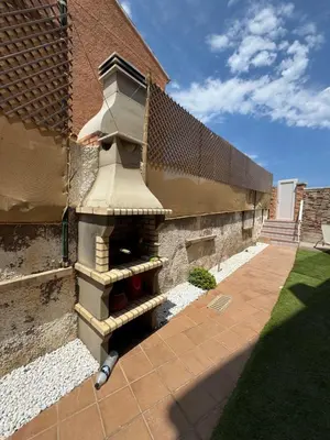 a stone building with a bird feeder on the side of it at El Encanto del Perelló in Sueca