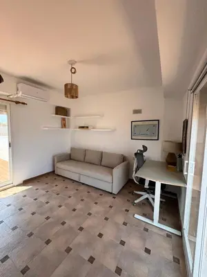 a living room with a couch and a table at El Encanto del Perelló in Sueca