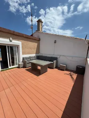 a patio with a bench and a table on a building at El Encanto del Perelló in Sueca