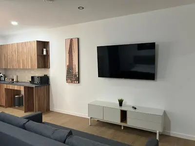 a living room with a couch and a tv on a wall at Turia Loft Valencia in Valencia