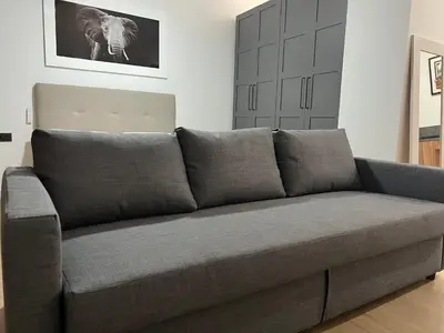 a gray couch in a living room with at Turia Loft Valencia in Valencia