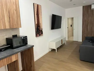a living room with a microwave and a tv on a wall at Turia Loft Valencia in Valencia
