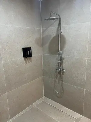 a shower with a glass door with a shower head at Turia Loft Valencia in Valencia