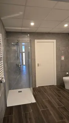 a bathroom with a shower and a glass door at Arena Legacy Modern Suits in Valencia