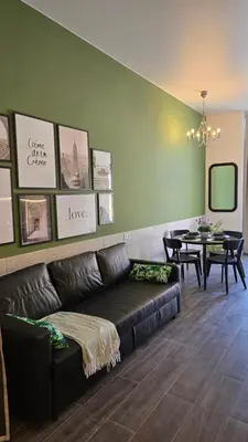 a living room with a leather couch and a table at Arena Legacy Modern Suits in Valencia