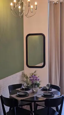 a table with chairs and a mirror on the wall at Arena Legacy Modern Suits in Valencia