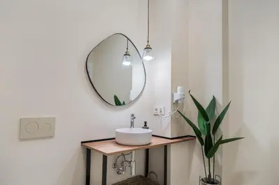 a bathroom with a sink and a mirror at Apartments LEON PARE RICO in Valencia