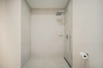 a bathroom with a shower with a roll of toilet paper at Apartments LEON PARE RICO in Valencia