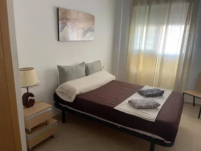 a bedroom with a bed and a bathroom at Acogedor piso en Benissanó in Benisanó