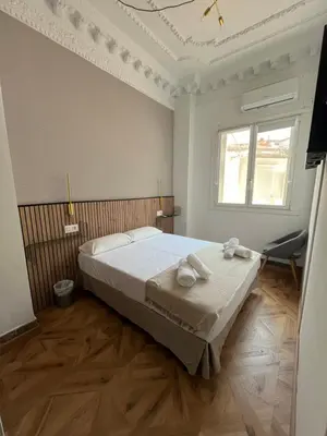 a bedroom with a bed with two towels on it at STAR Plaza España in Valencia