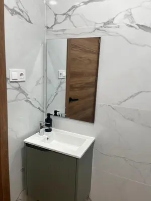 a white bathroom with a sink and a mirror at STAR Plaza España in Valencia