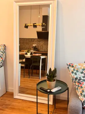 a mirror in a living room with a table at Loft Llum Valencia in Valencia