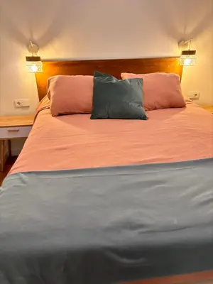 a large bed with two pillows on top of it at Loft Llum Valencia in Valencia