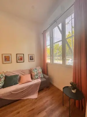 a living room with a couch and a large window at Loft Llum Valencia in Valencia