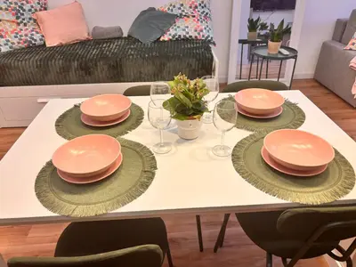 a dining room table with plates and wine glasses at Loft Llum Valencia in Valencia