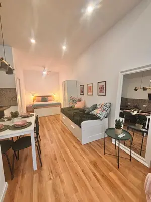 a living room with a bed and a table at Loft Llum Valencia in Valencia