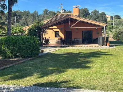 a small house with a lawn in front of it at Casa en la naturaleza de Chella in Chella