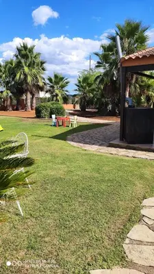 a park with palm trees and a grass field at Casa en la naturaleza de Chella in Chella