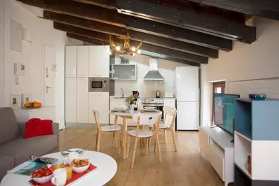 a kitchen and living room with a table and chairs at SingularStays San Vicente in Valencia