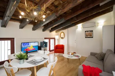 a living room with a couch and a table and a tv at SingularStays San Vicente in Valencia