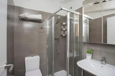 a bathroom with a shower and a toilet and a sink at SingularStays San Vicente in Valencia