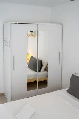 a bedroom with a glass partition with a bed at Apartamento Ciudad de las Ciencias con Terraza in Valencia