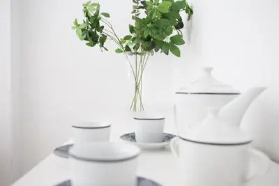 a white table with a vase with a plant in it at SingularStays Na Jordana in Valencia