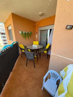 a balcony with a table and chairs in a room at TODO INCLUIDO - Wifi,playa,piscina 24h,garaje,terraza y Mercadona -MUY CÓMODO in Canet de Berenguer