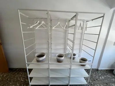 a closet with white shelving and three cups at District Key - Puerto de Sagunto, Asturias in Puerto de Sagunto