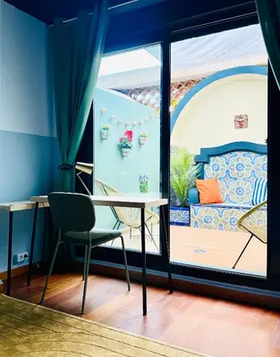 a table and a chair in a room with a window at Trendy Ruzafa Neighborhood - Spacious Luxury 3BR with Double Terrace in Valencia