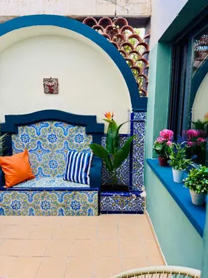 a bench on the side of a building with plants at Trendy Ruzafa Neighborhood - Spacious Luxury 3BR with Double Terrace in Valencia