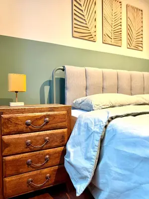 a bedroom with a bed and a dresser with a lamp at Trendy Ruzafa Neighborhood - Spacious Luxury 3BR with Double Terrace in Valencia