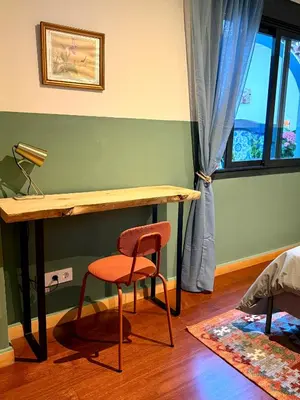 a desk and a chair in a room with a window at Trendy Ruzafa Neighborhood - Spacious Luxury 3BR with Double Terrace in Valencia