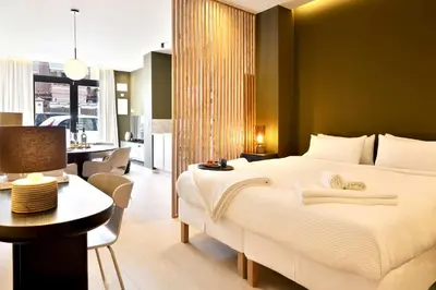 a bedroom with a large white bed and a dining room at SariStays Valencia Finca Verde L in Valencia