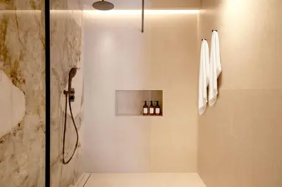 a bathroom with a shower with bottles on a wall at SariStays Valencia Finca Verde R in Valencia