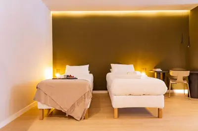 a hotel room with two beds and a chair at SariStays Valencia Finca Verde R in Valencia
